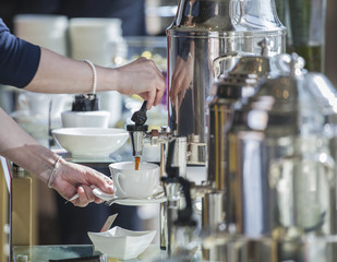 hand pours coffee