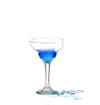 Martini glass with blue water and broken glass