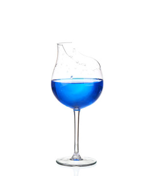 Martini glass with blue water and broken glass