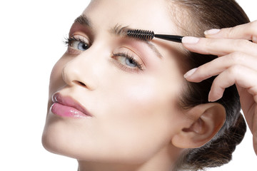 Closeup beautiful woman with eyebrow brush tool