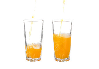 Pouring orange juice into the glass isolated on white