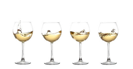 WHITE wine swirling in a goblet wine glass, isolated on a white