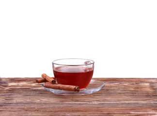 Glass cup of  tea with cinnamon sticks isolated on white