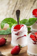 Homemade strawberry yogurt with fresh wild strawberries and mint