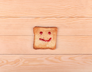 slice of bread with a smile on a wooden