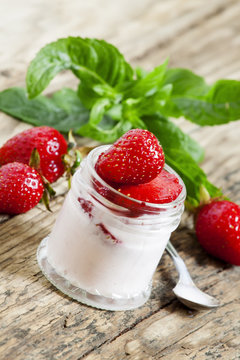 Homemade strawberry yogurt with fresh strawberries and mint in a
