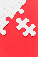 Incomplete white puzzle with red color background