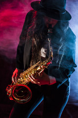 Fototapeta na wymiar Young lady with her saxophone