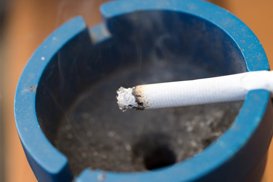 Cigarette / smoldering cigarette in an ashtray