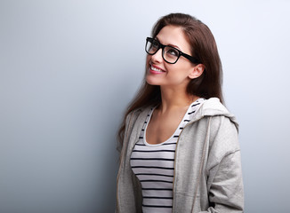 Beautiful thinking young woman in glasses looking up