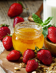 Jar of honey, strawberries, muesli, milk bottle, healthy eating