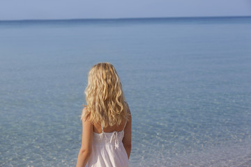 Fototapeta na wymiar woman meditating and relaxing on beach