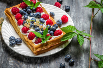 Waffels with cream and blueberry and raspberry