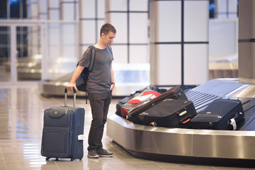 Fototapeta na wymiar Young man waiting for luggage