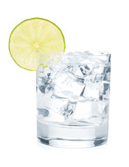 Glass of pure water with ice cubes and lime slice