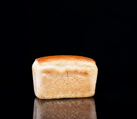 Bread on a black background with reflection