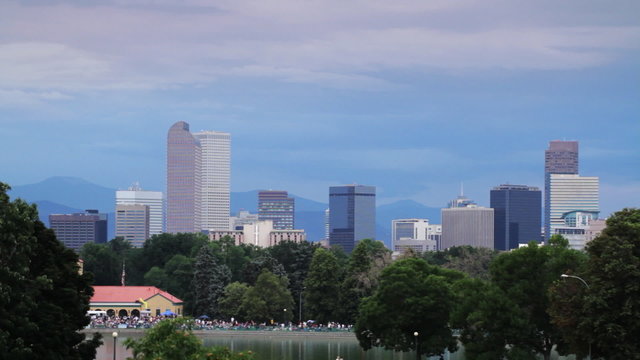 Park in Denver, Colorado, with city skyline and mountains in the background.