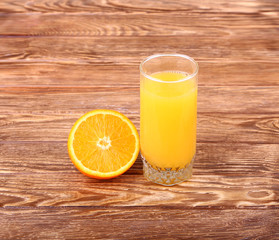 Glass of freshly pressed orange juice with sliced orange