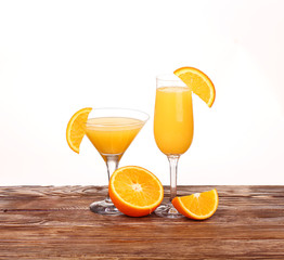 Glass of freshly pressed orange juice with sliced orange