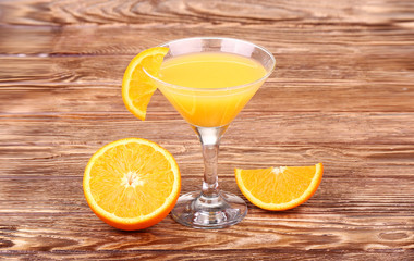 Glass of freshly pressed orange juice with sliced orange