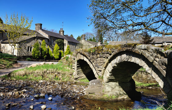 Thirteenth century packhorse bridge and the village of Wycoller.