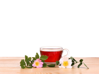 Herbal tea in a glass cup, fresh flowers 
