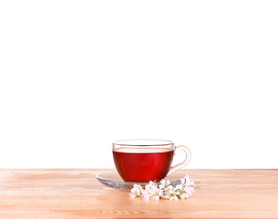 Herbal tea in a glass cup, fresh flowers 