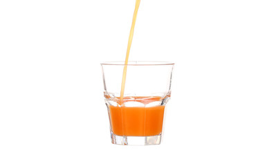 Juice pouring into glass isolated on white