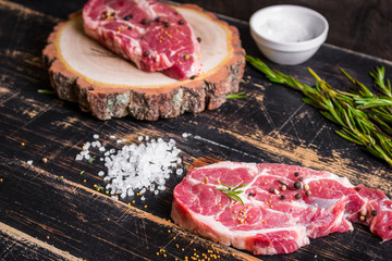 Raw juicy meat steak on dark wooden background ready to roasting