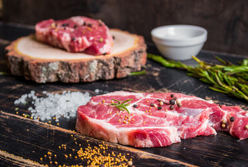 Raw juicy meat steak on dark wooden background ready to roasting