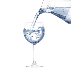 Pouring water from glass pitcher on white 