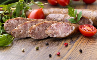 Smoked sausages with herbs, greens,  tomatoes