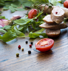 Smoked sausages with herbs, greens,  tomatoes