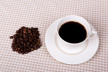 Black coffee cup with coffee beans