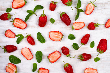 Sweet red strawberries on old white table, view from above, studio shot