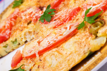 Omelet with cauliflower, tomatoes, fresh herbs and cheese 