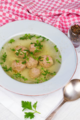 Meatballs in broth with parsley