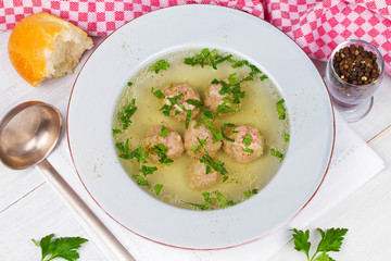 Meatballs in broth with parsley