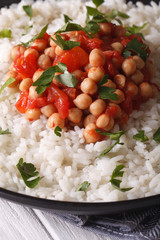 Rice with chickpea curry and herbs closeup vertical
