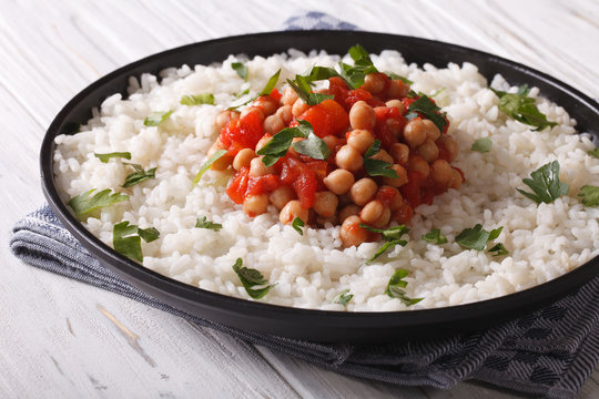Chickpeas in tomato sauce with rice close-up. Horizontal
