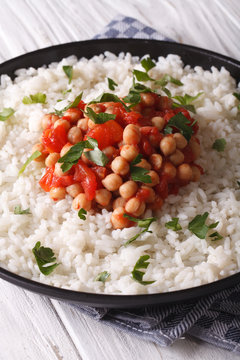 Chickpeas in tomato sauce with rice in a dish close-up