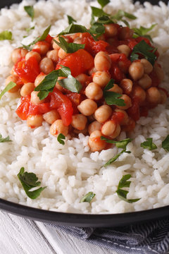 Rice with chickpea curry and herbs closeup vertical
