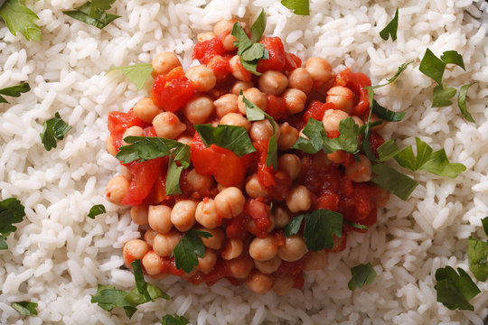 Rice with chickpeas and herbs macro background