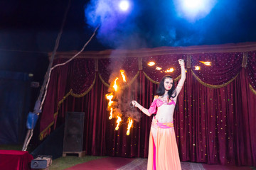 Exotic Fire Dancer Twirling Flaming Batons