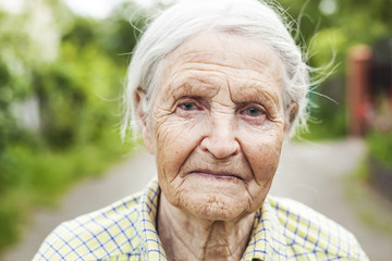 Portrait of an aged woman outdoors 