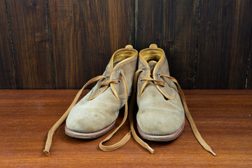 Desert boots on wooden background