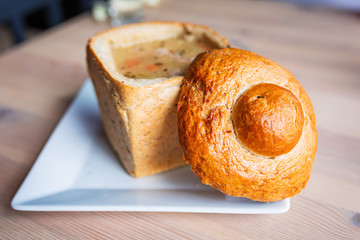 Tasty soup served in baked bread bowl