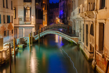 Nacht zijkanaal en brug in Venetië, Italië