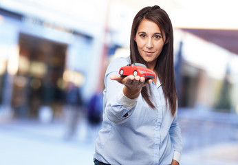 young woman showing a red car © asierromero