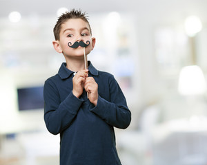 little kid joking with a moustache